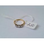 A three stone diamond ring in 18ct gold size N