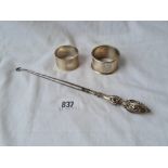 Two napkin rings and a button hook