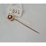 An unmarked gold Maltese cross topped stick pin