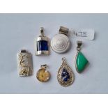 Six silver stone set pendants