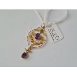 An attractive yellow metal amethyst set pendant