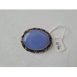 A silver oval blue hard stone brooch