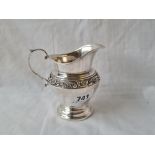 Sterling silver cream jug with chased band. 4 in high. 100gms