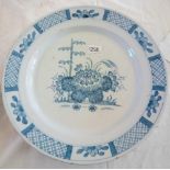 Delft dish painted with flowers. 13in diam