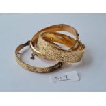 Three 9ct gold/metal core bangles