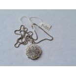 A silver locket on a silver chain