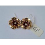 A pair of ruby and diamond flower head clip on earrings in 9ct mounts 7.7g inc