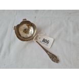 Tea strainer with decorated handle. Sheffield 1935 by E V.55gms.