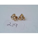 A pair of three colour 9ct knot ear studs 2.9g