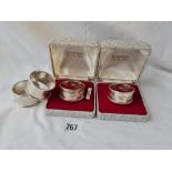 Four napkin rings including a pair in fitted boxes. 72gms.