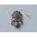 An unusual silver brooch with two birds over urn with purple stone