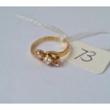 A three stone diamond twist ring in 18ct gold mount size K 2.2g