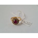 A ruby & diamond cluster ring in 18ct gold - size R - 5.1gms