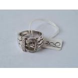 A white gold diamond buckle ring in 9ct gold - size S - 10.2gms