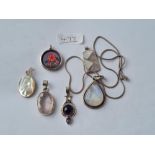 Six silver stone set pendants
