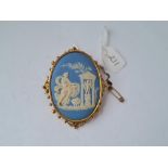 A large carved Wedgwood cameo brooch in scroll and ball gold mount 24g inc