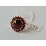 A large garnet cluster ring in 9ct - size M - 6.4gms