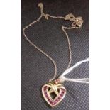 A 9ct GOLD & RUBY HEART SHAPED PENDANT ON 9ct BECK CHAIN