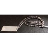 A SILVER INGOT ON A SILVER NECK CHAIN