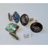 A pair of silver and abalone cufflinks and a silver niello pair