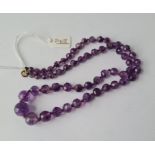 An amethyst bead necklace with yellow metal claps