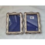 A pair of Edwardian photo frames with scroll decorated borders 7 inches high Birmingham 1907