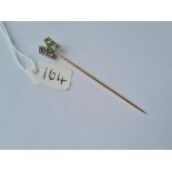 A vintage stick pin with initialled PA in diamonds & emerald stones in gold unmarked