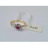 A three stone diamond & ruby ring in 18ct gold mount size K 2.9g