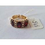 A garnet 7 stone ring in 9ct - size - 7.3gms