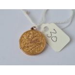 A circular 9ct back and front locket