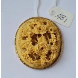 Large carved bone floral pendant in gold mount