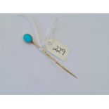 An unusual turquoise and gold stick pin opening to concealed locket