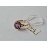 A large purple stone ring in 9ct - hallmarked - size N - 2.7gms