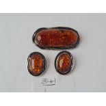 A pair of oval amber earrings & large silver oval amber brooch