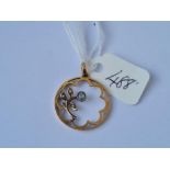 A circular floral stone set gold pendant