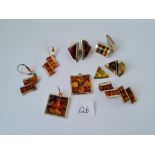 A bag of silver and reconstituted amber earrings