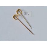 Two horseshoe topped stick pins - 1x 15ct gold - 1 x 9ct - 2.7gms