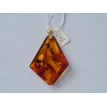 A gold topped large amber pendant