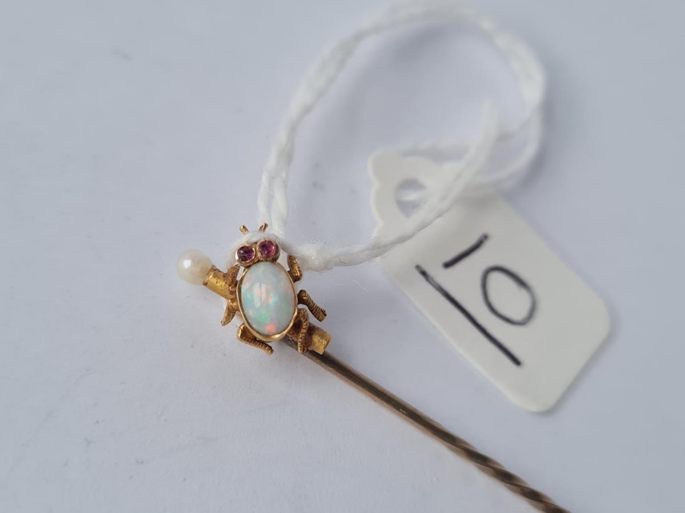 A Victorian opal set bug stick pin with ruby eyes in 15ct gold