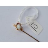 A Victorian opal set bug stick pin with ruby eyes in 15ct gold