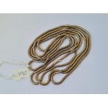 A long rolled gold snake link chain