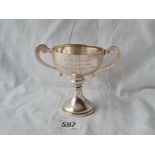 A two handled trophy cup on pedestal stem 4 1/2 inches over handles, Birmingham 1927 64 gms