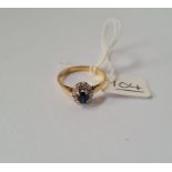 A sapphire & diamond cluster ring in 18ct gold - size N - 2.8gms