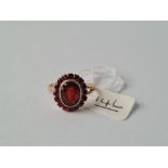 A garnet cluster ring in 9ct - size P.5 - 2.7gms