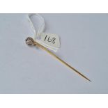 A nice gold umarked stick pin with diamond crown top in platinum