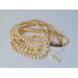 A triple row graduated pearl necklace with silver clasp