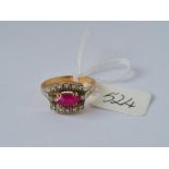 An attractive red stone and diamond cluster ring in 18ct gold mount size O 5.2g