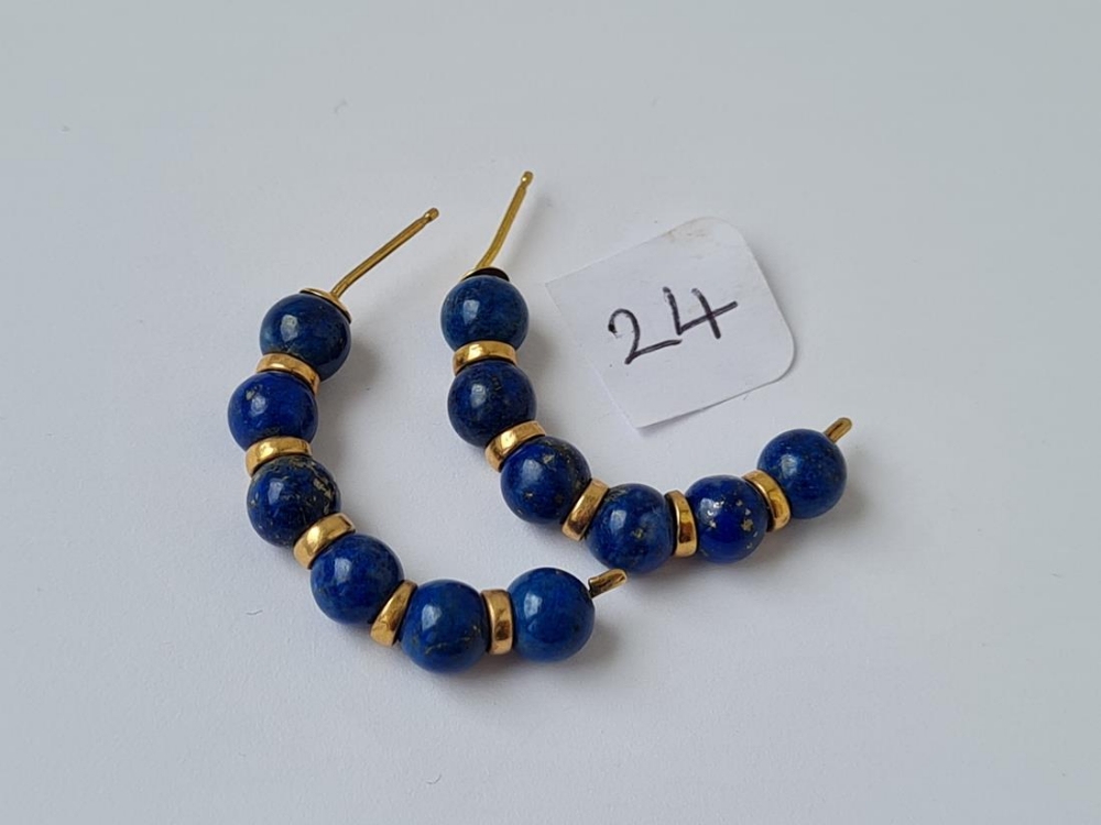 A pair of half hoop gold and lapis earrings