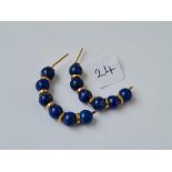 A pair of half hoop gold and lapis earrings