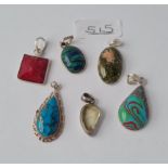 Six silver mounted stone pendants